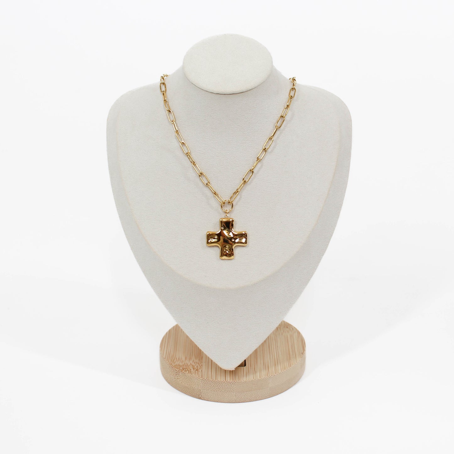 Gold cross chain necklace on mannequin with a white background 