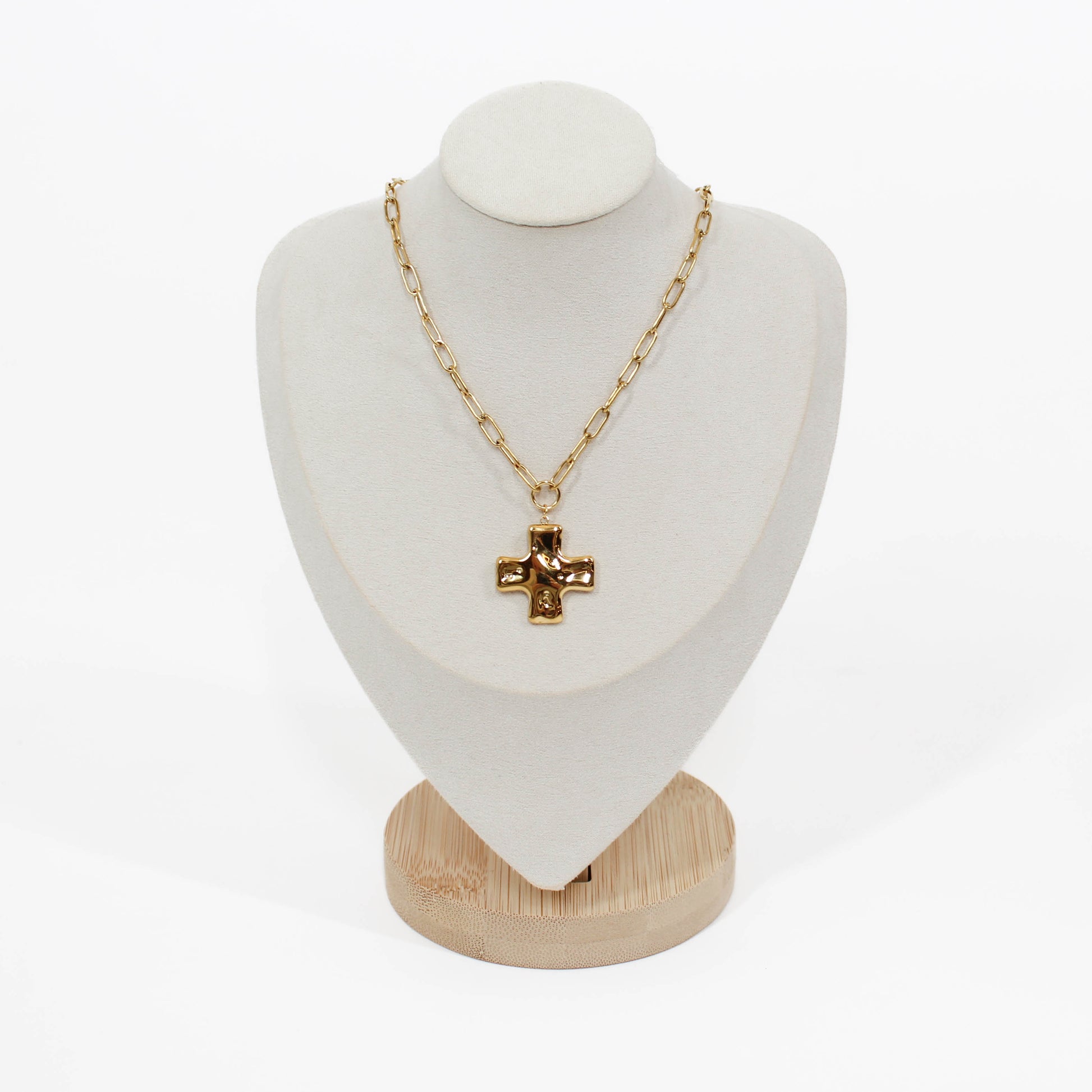Gold cross chain necklace on mannequin with a white background 