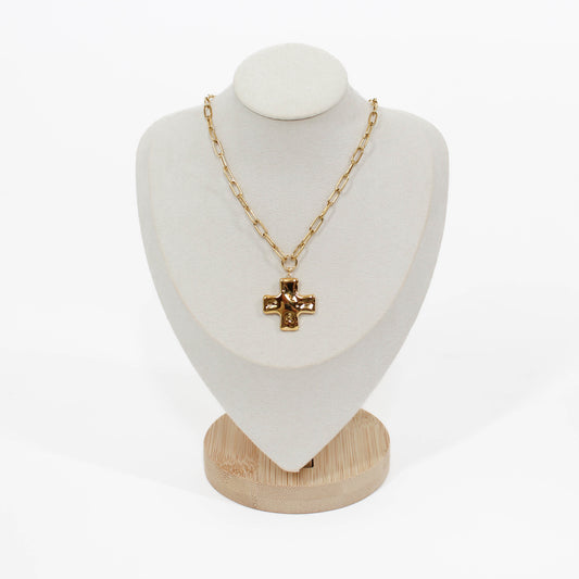 Gold cross chain necklace on mannequin with a white background 