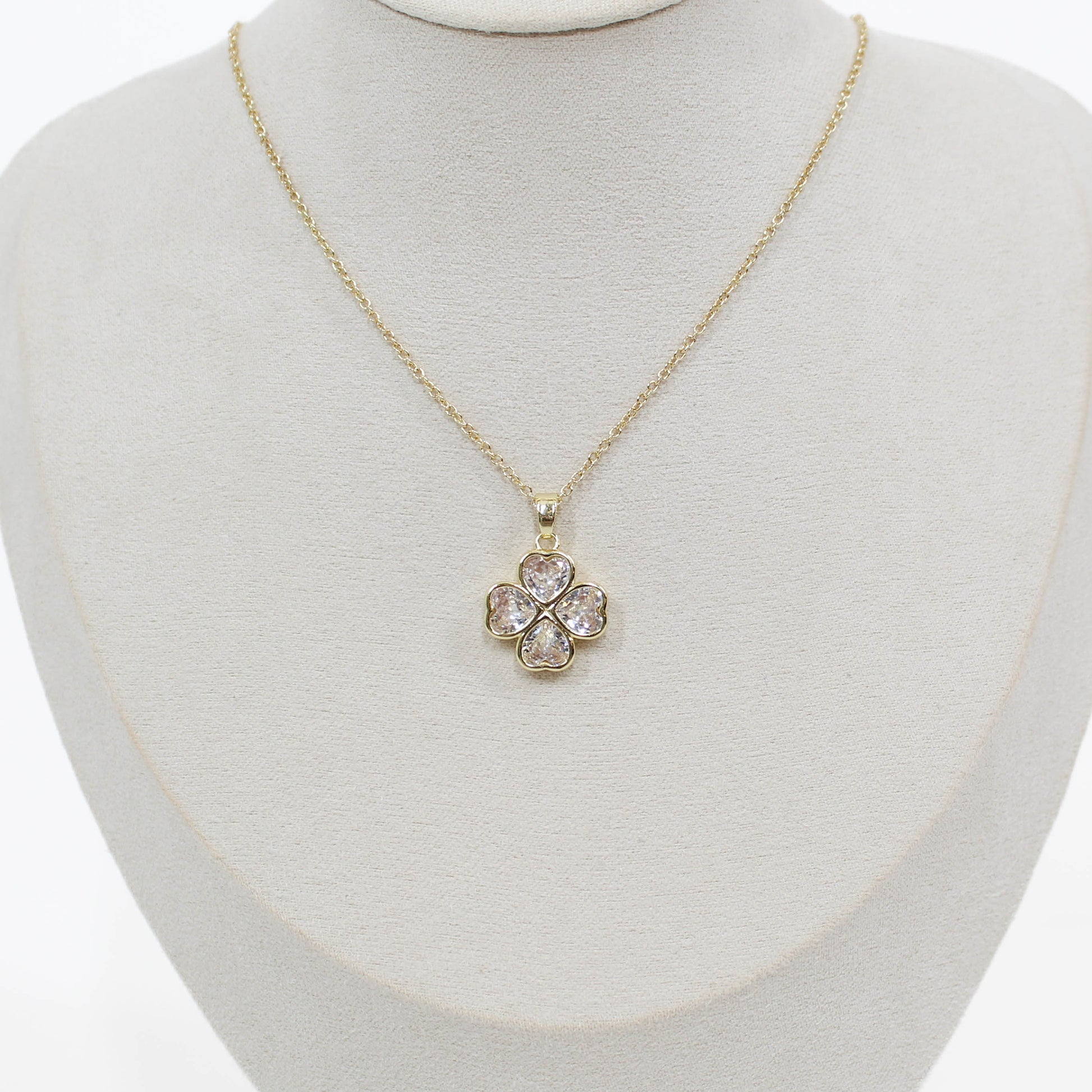 Crystal Clover Necklace on a mannequin with a white background 