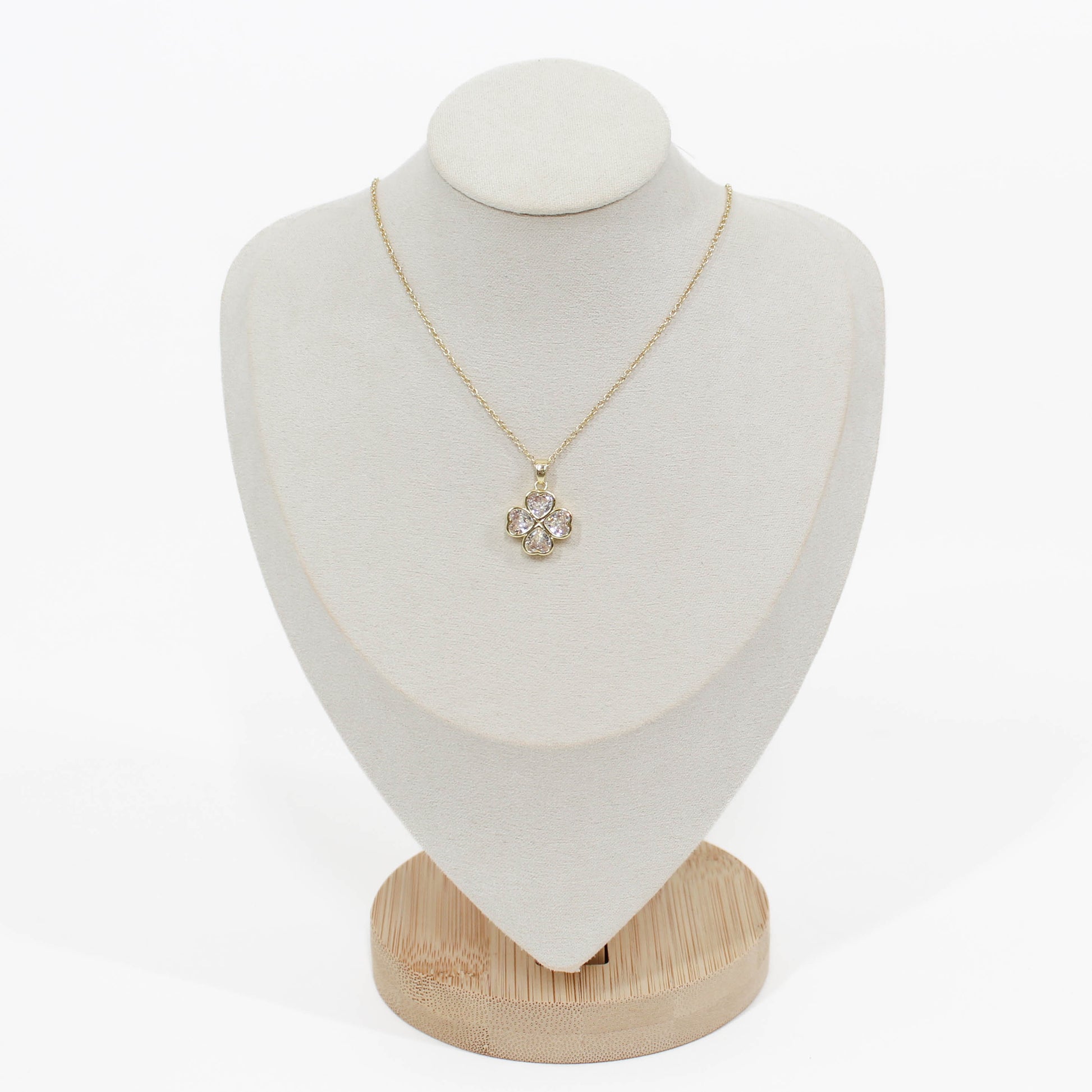 Crystal Clover Necklace on a gold chain on a mannequin with a white background
