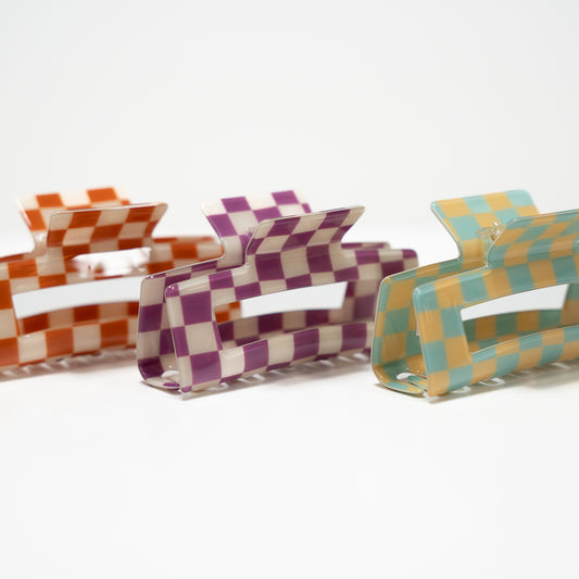 Checkered orange and white claw clip, checkered purple and white claw clip, checkered yellow and blue claw clip