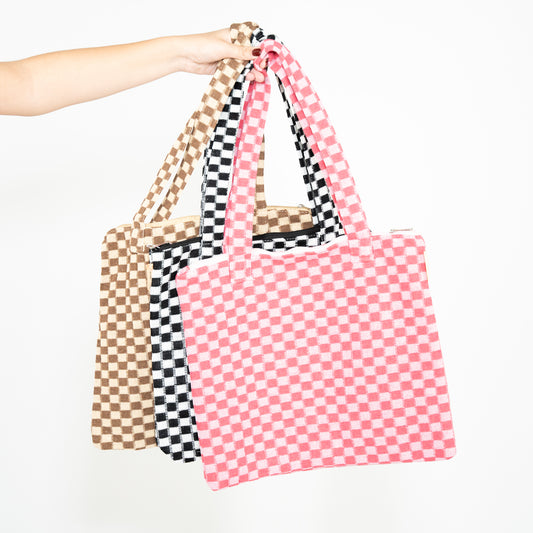 Tan and beige checkered tote bag, black and white tote bag, and light pink and hot pink checkered tote bag