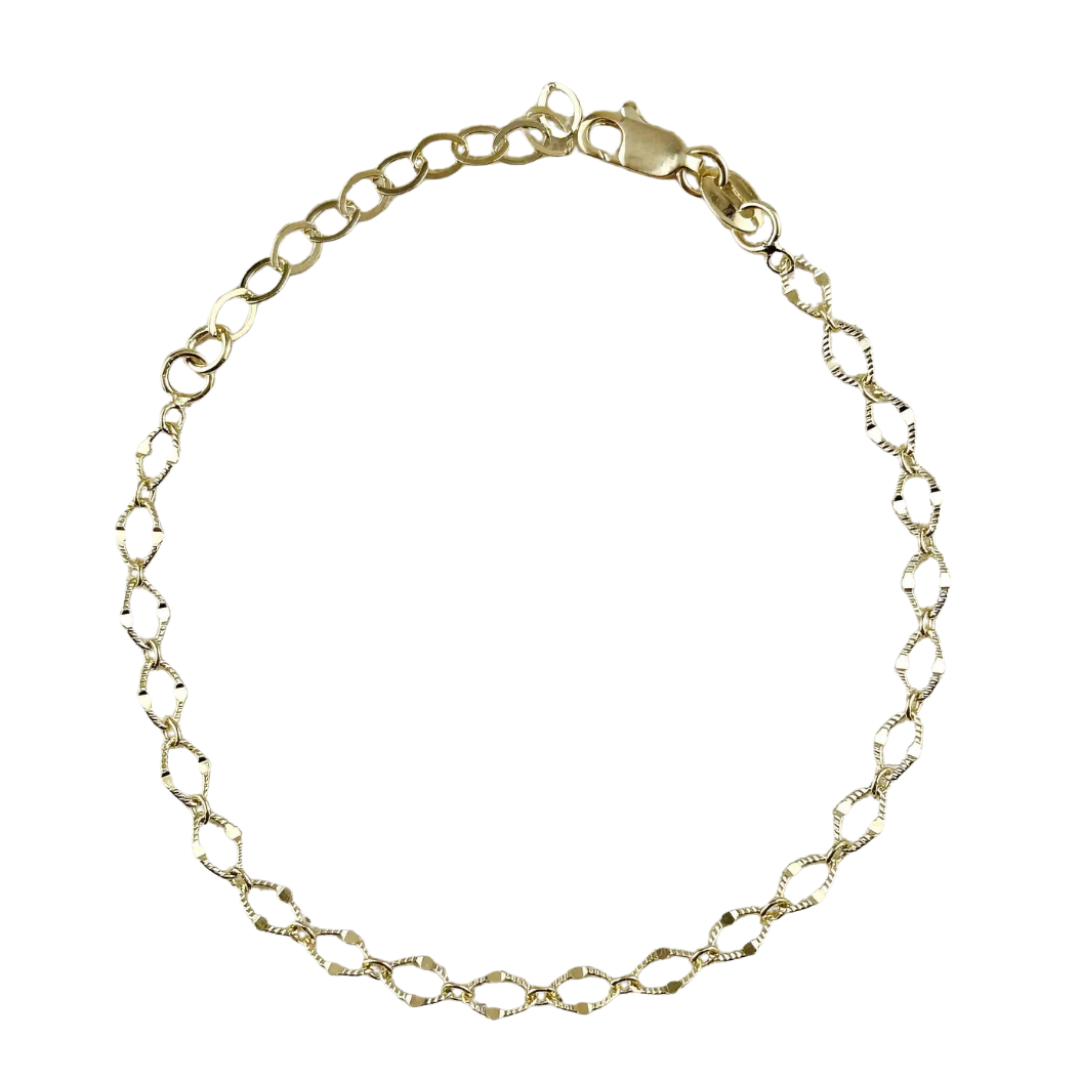 Gold diamond cut chain bracelet on a white background