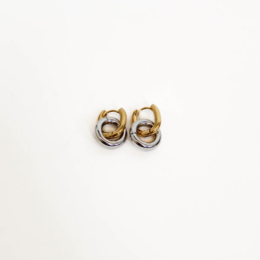 Pair of gold and silver mixed metal double hoop earrings on a white background