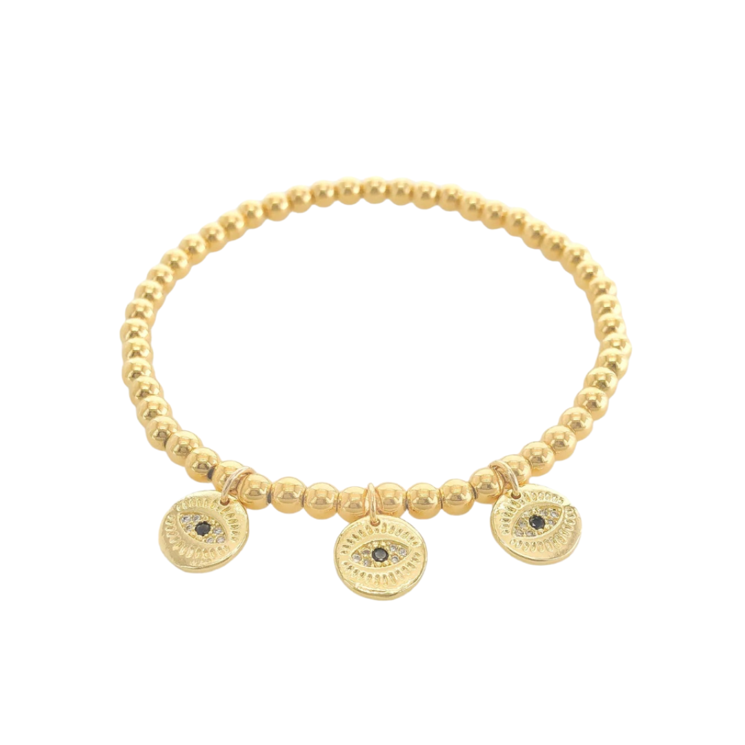 Gold beaded bracelet with circular evil eye charms on a white background