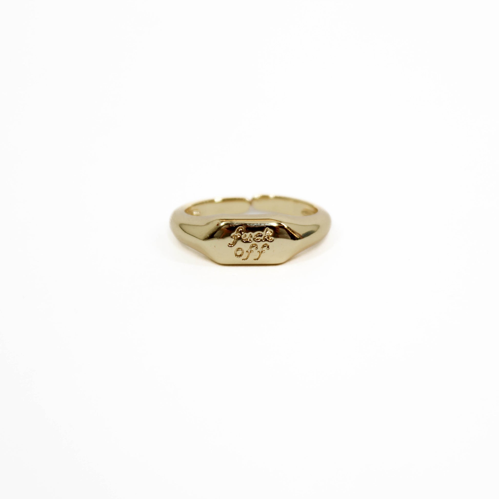 Gold ring with 'f**ck off' engraving on a white background