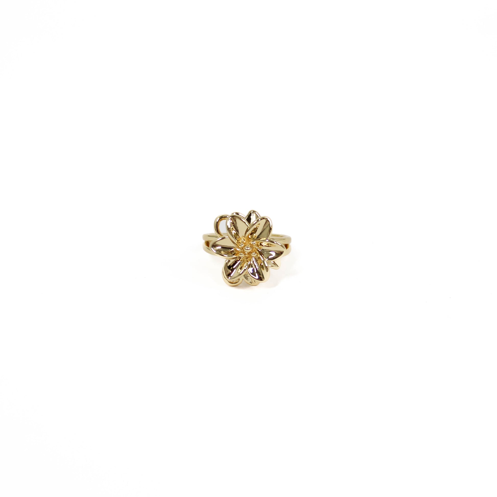Gold flower-shaped statement ring on a white background