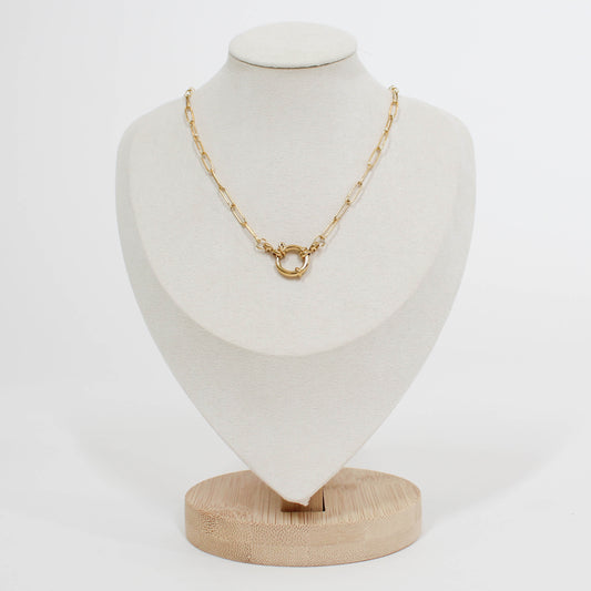 Gold front clasp necklace on a white mannequin bust with a white background