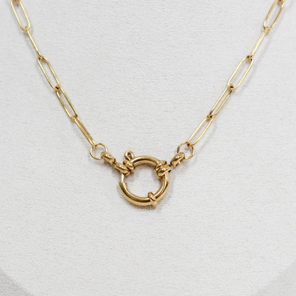 Gold necklace with a front clasp on a white background