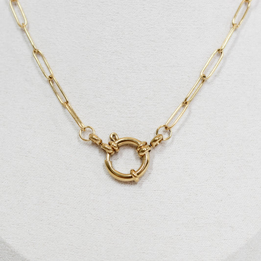Gold necklace with a front clasp on a white background