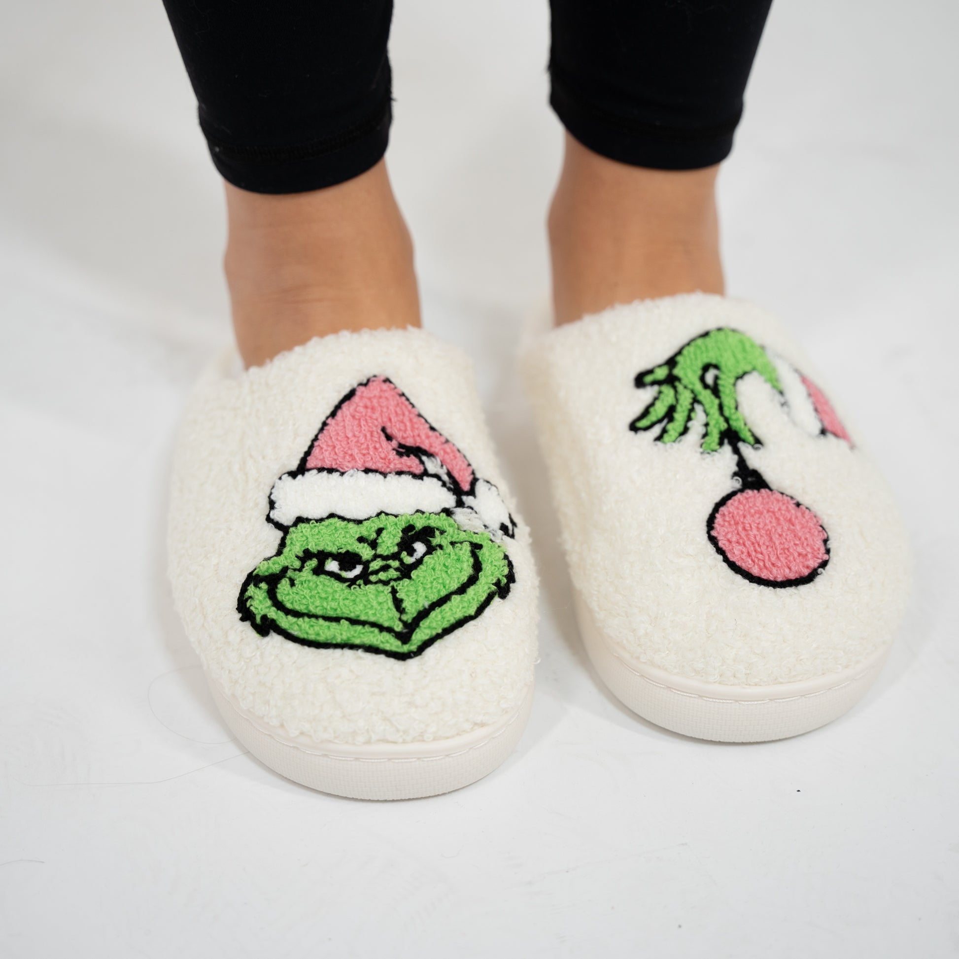 Fuzzy grinch slippers on