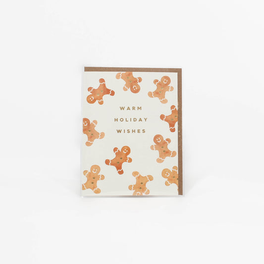 Greeting card with gingerbread men pattern and 'Warm Holiday Wishes' text on a white background