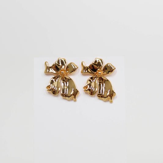 Pair of gold floral earrings on a white background