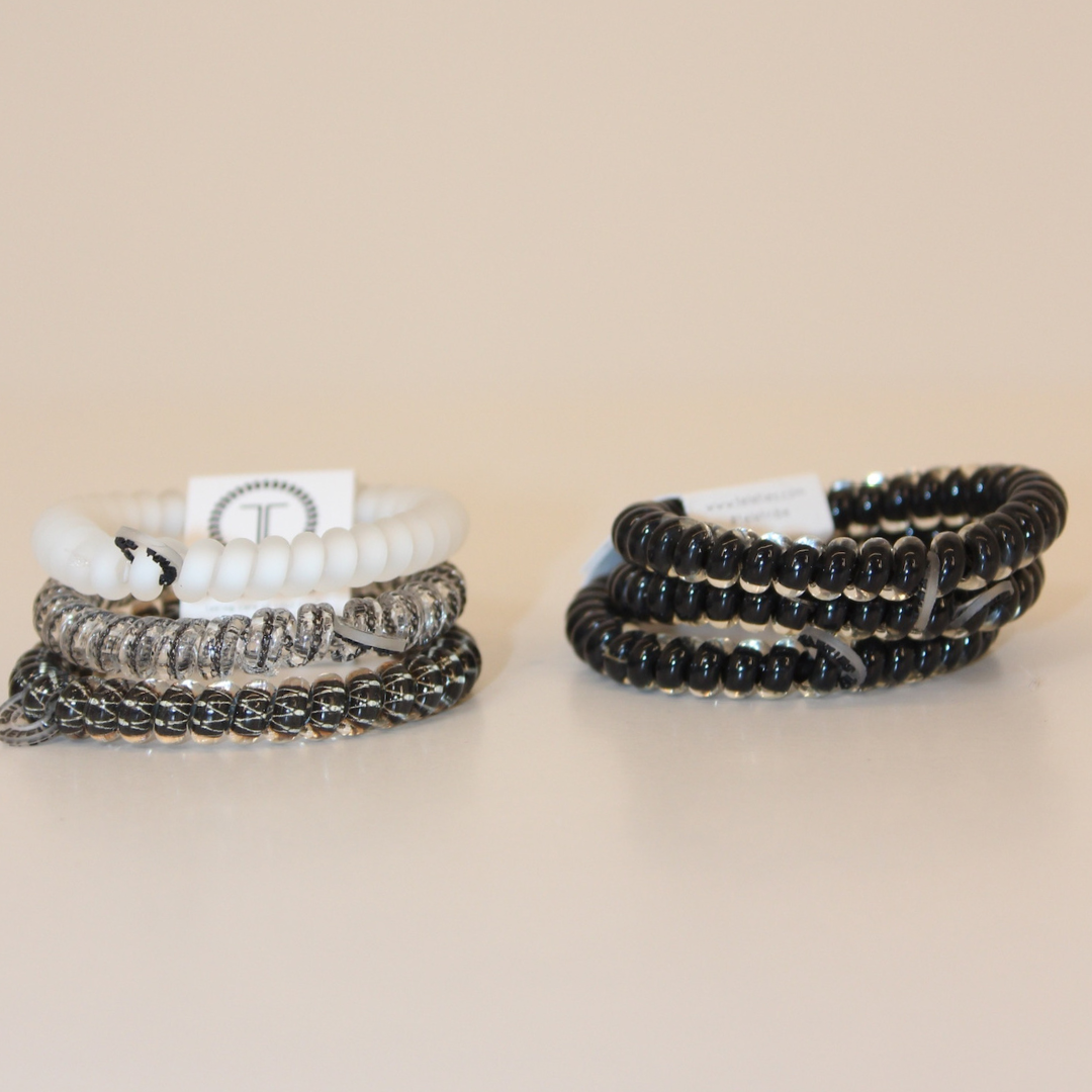 Grey multicolored hair ties and black hair ties