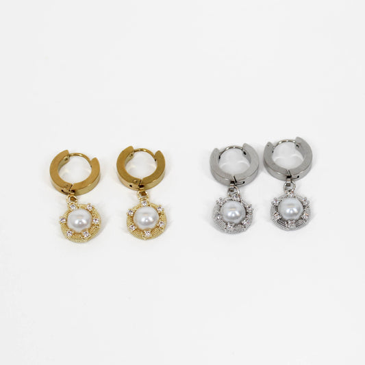 Silver and gold halo pearl drop earrings on white background