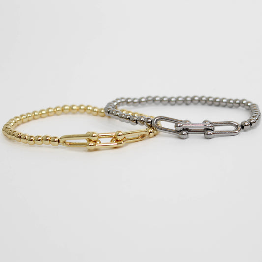 Two gold and silver chain stretch bracelets on a white background