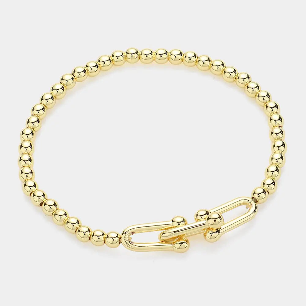 Gold beaded stretch bracelet with a hardware clasp on a white background