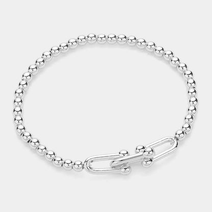 Silver beaded stretch bracelet with a hardware clasp on a white background