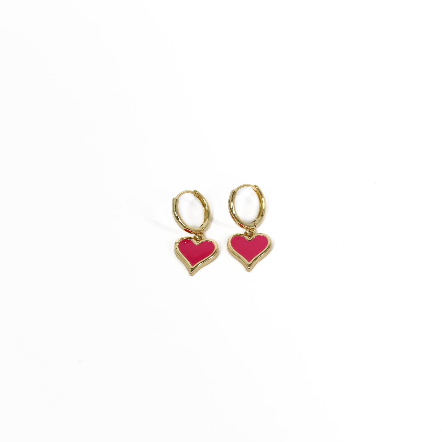 Gold heart-shaped heart drop huggie earrings on a white background