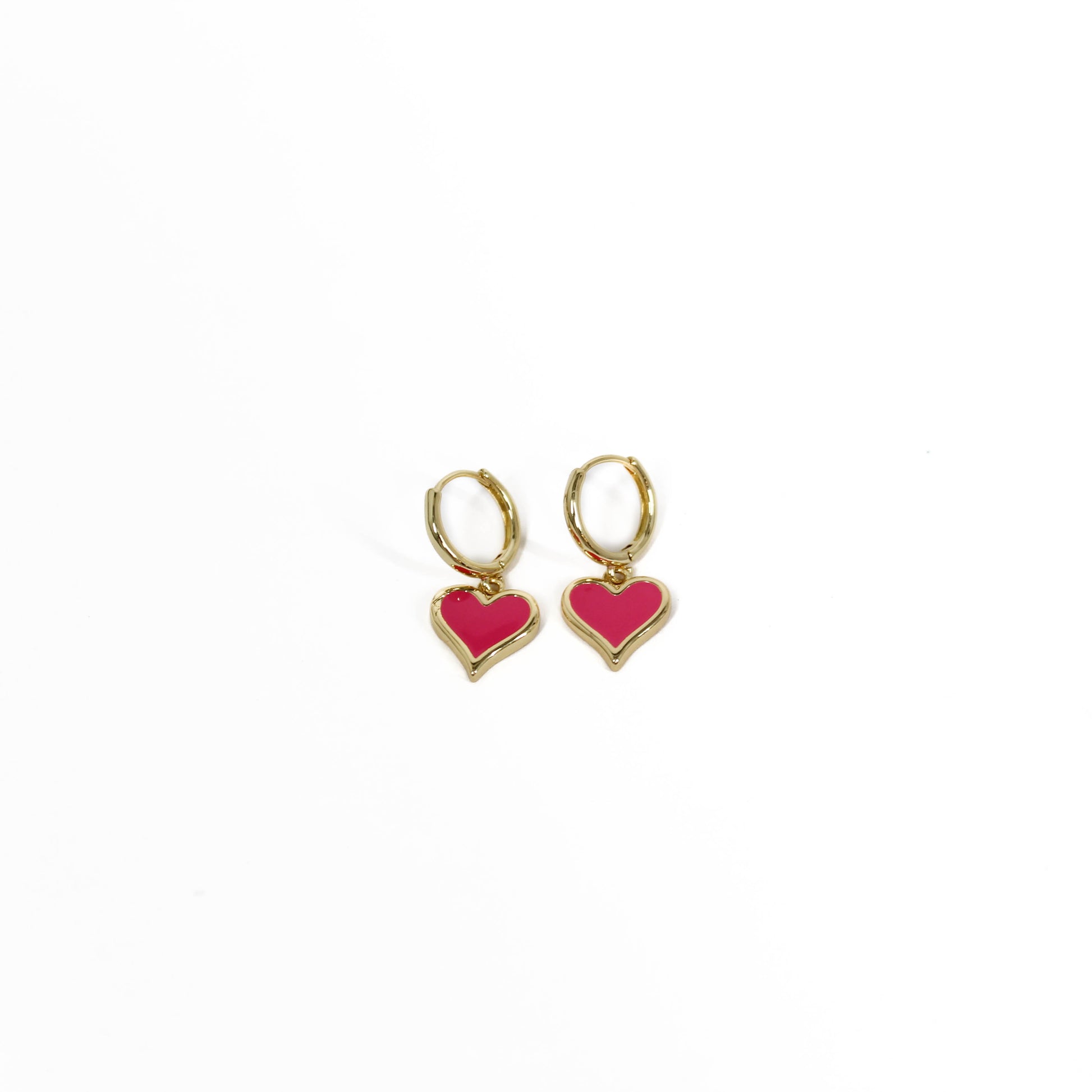 Gold heart-shaped heart drop huggie earrings on a white background
