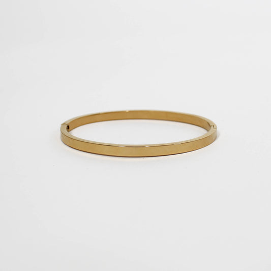 Gold bangle on a white background