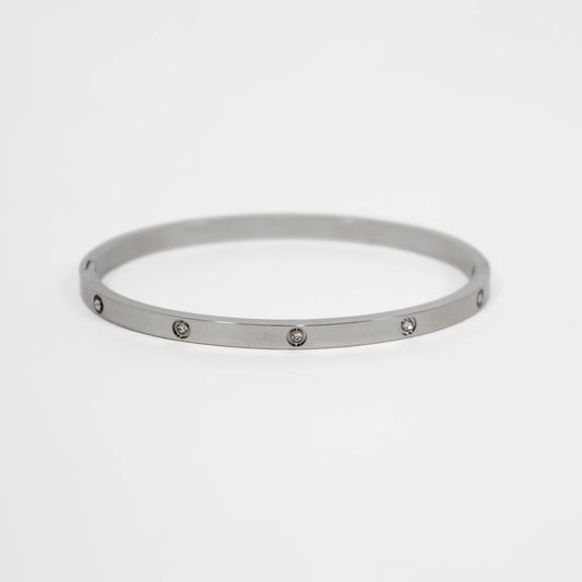 Silver bracelet with small stones on a white background