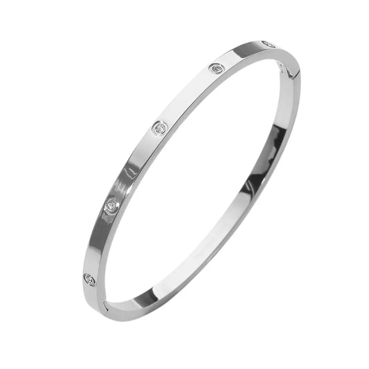 Silver hinged bracelet with small diamonds on a white background
