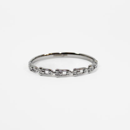 Silver chain industrial link hinged bangle bracelet on a white background