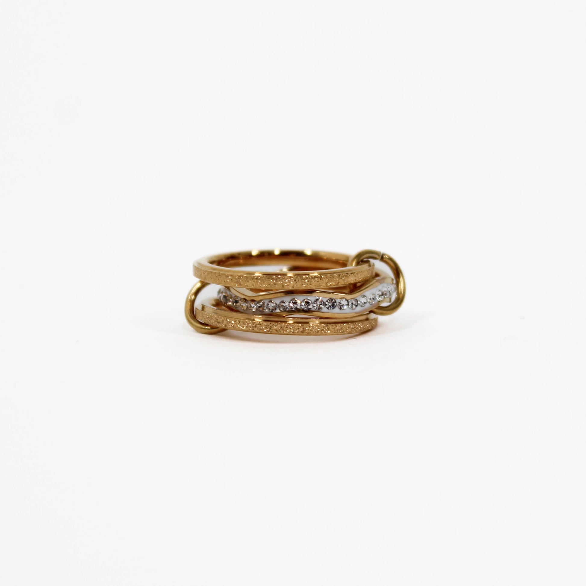 Gold interlocking link ring with embedded diamonds on a white background