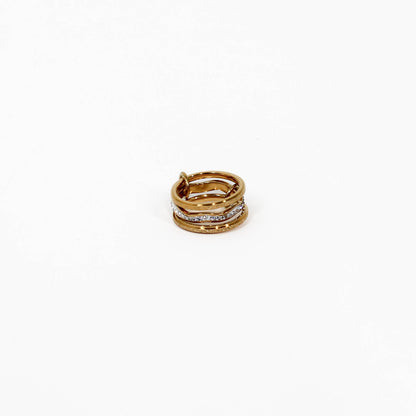 Gold and silver interlocking link ring crystal with embedded stones on a white background