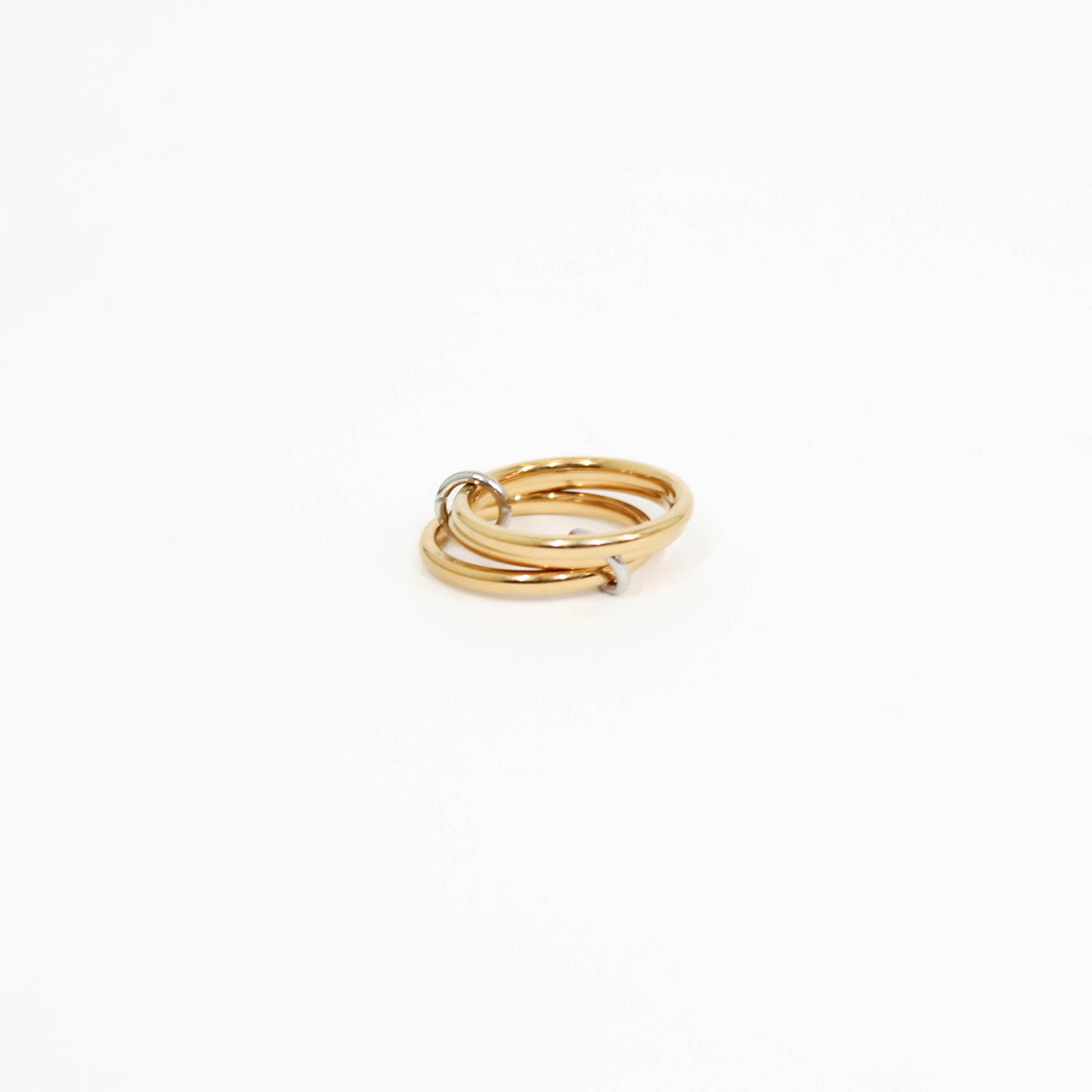 Gold interlocking link ring on a white background