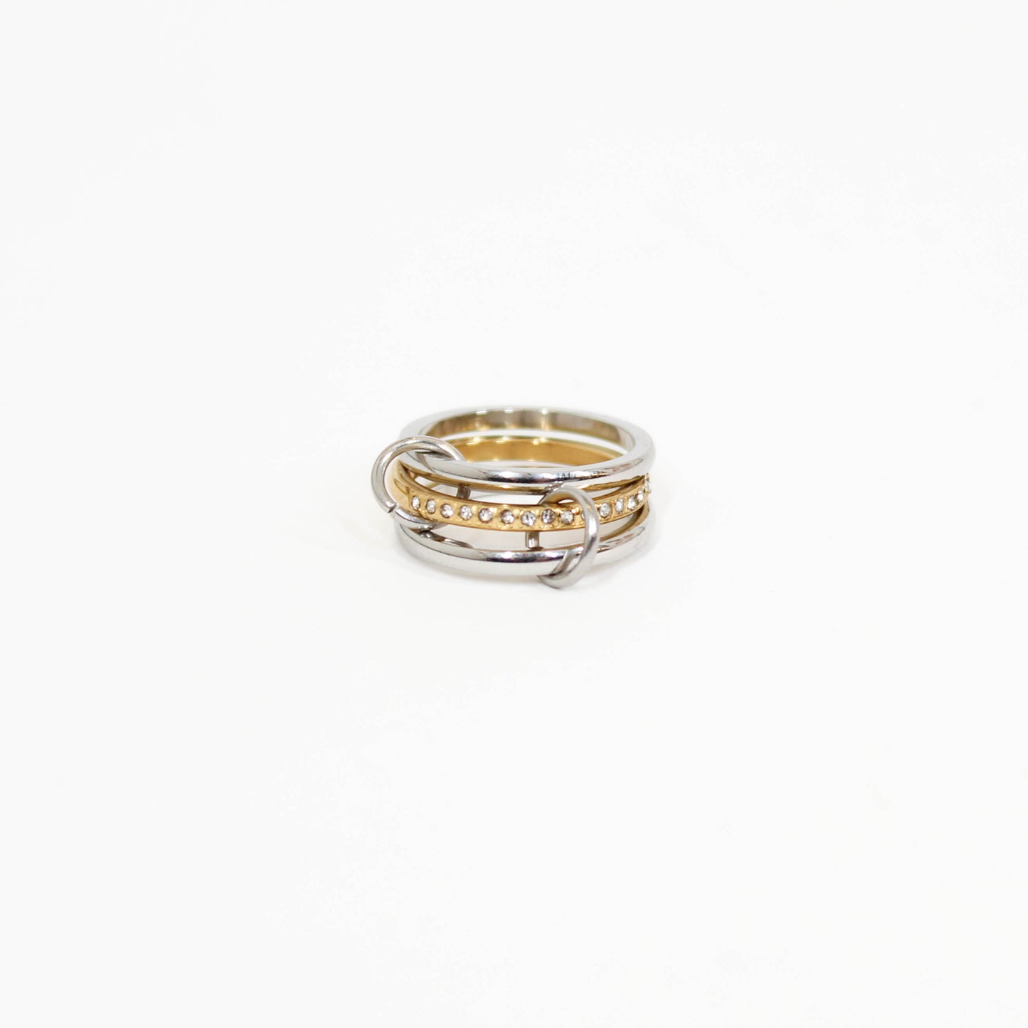 Interlocking link ring in mixed metal on a white background