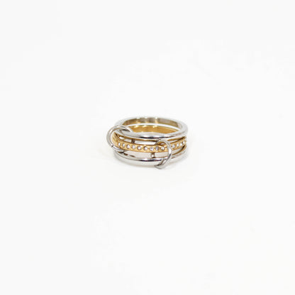Interlocking link ring in mixed metal on a white background