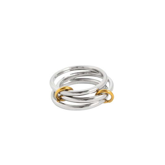 Stack of silver and gold rings interlocking link rings in mixed metals on a white background