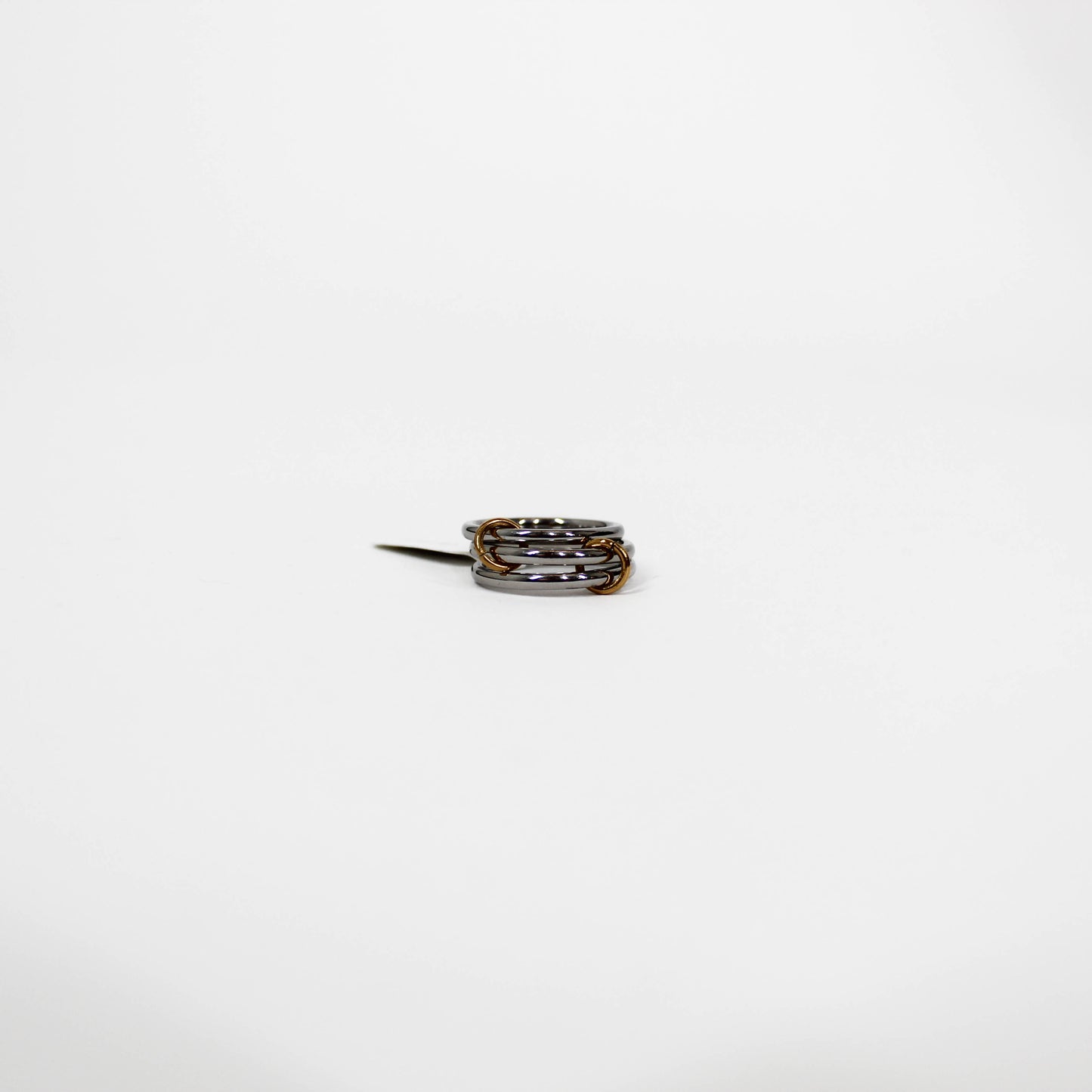 silver interlocking link Ring with multiple bands on a white background