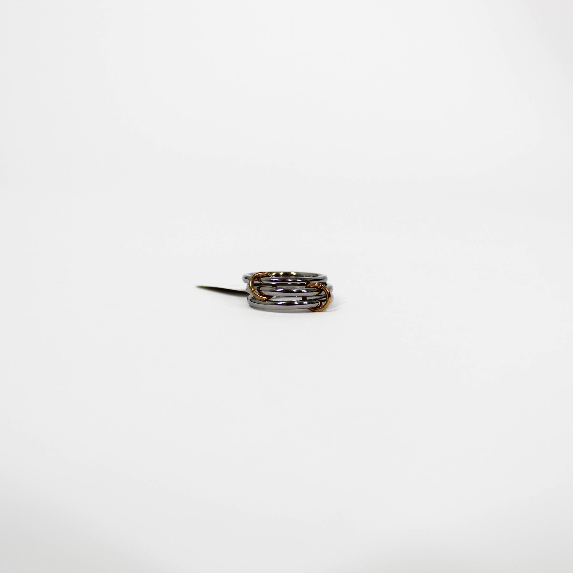 silver interlocking link Ring with multiple bands on a white background