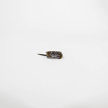 silver interlocking link Ring with multiple bands on a white background