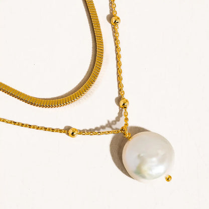 short gold necklace layered with gold necklace with pearl on white background