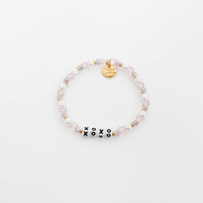 Beaded little words project bracelet with 'xoxo' beads on a white background
