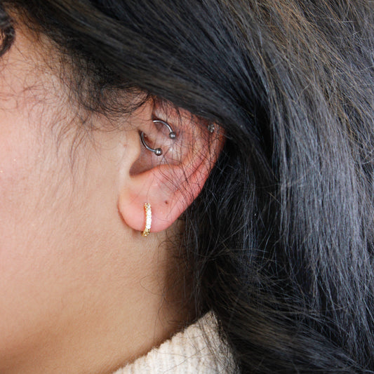 Mini Huggie Hoop Earrings gold on model