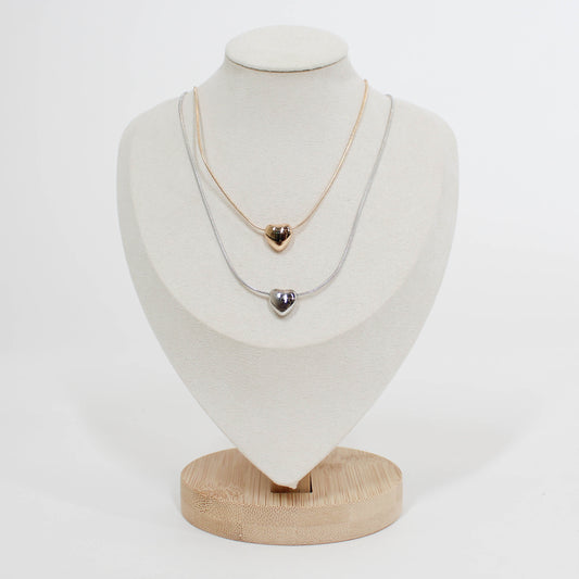 Necklace with heart-shaped pendants on a mannequin bust against a white background