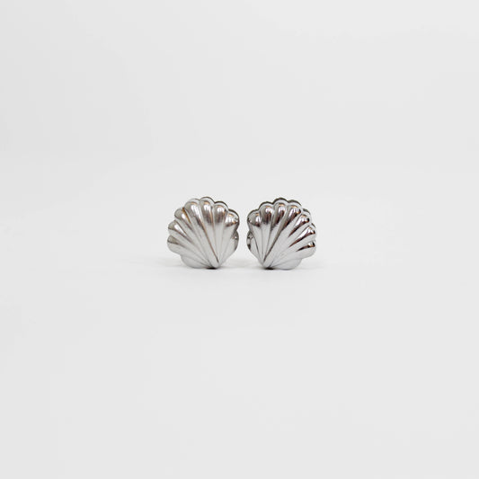 silver shell-shaped earrings on a white background