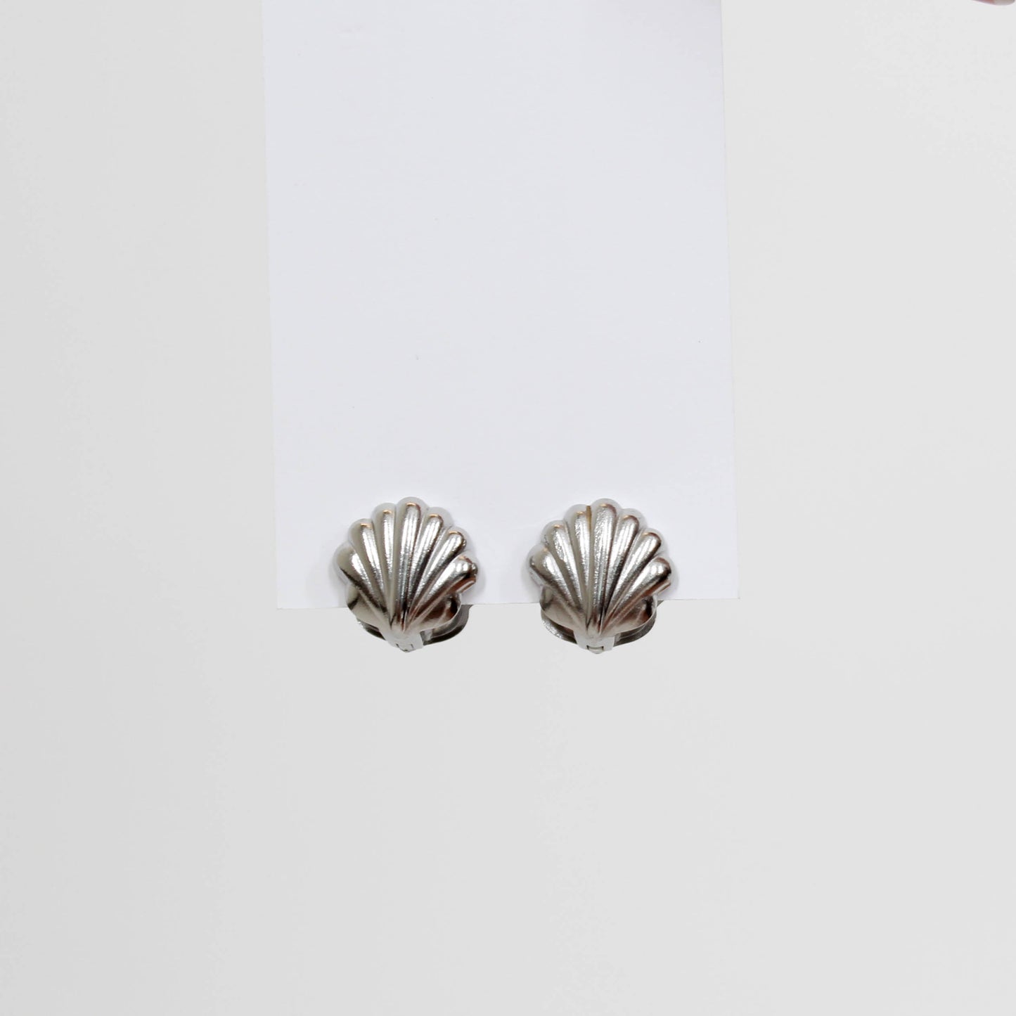Silver shell-shaped earrings on a white background