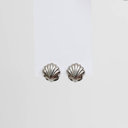 Silver shell-shaped earrings on a white background