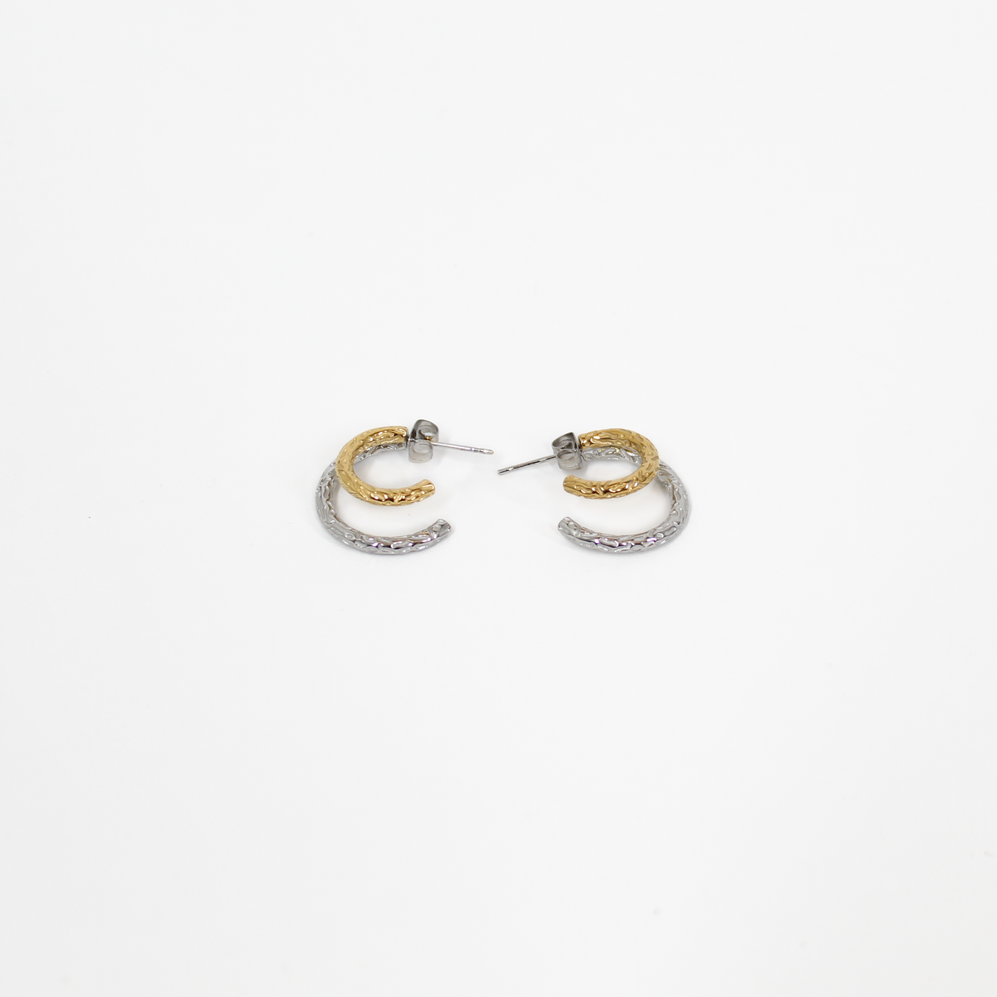 Pair of gold and silver mixed metal double hoop earrings on a white background