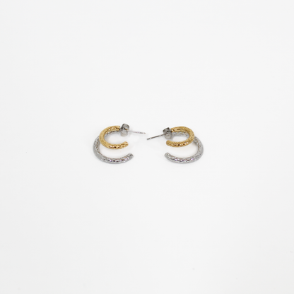 Pair of gold and silver mixed metal double hoop earrings on a white background