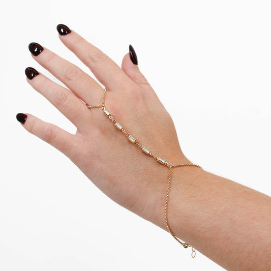 Gold mother of pearl hand chain on a white background