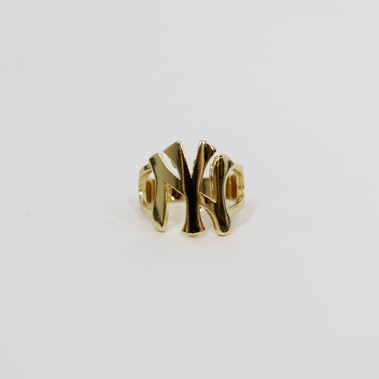 Gold ring with 'NY' design on  white background