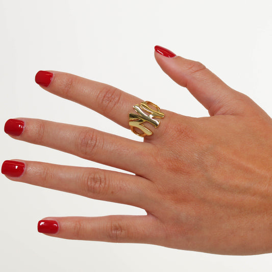 NY Gold band ring on a white background